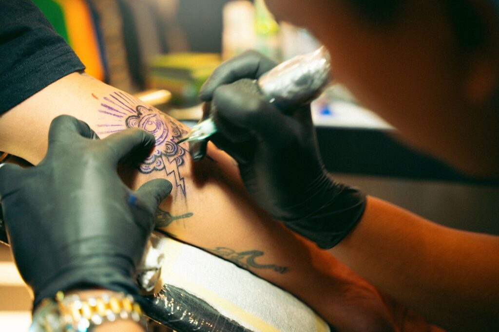 Tattoo artist discussing design options with a client during consultation