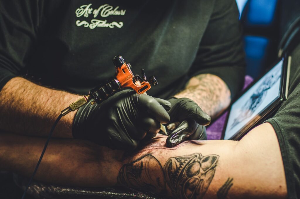 Artist and client reviewing custom tattoo design concepts together
