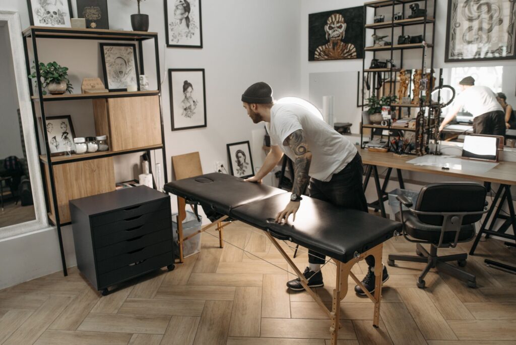 Professional tattoo artist at their equipped station preparing for a session